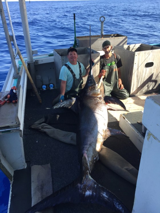 a person holding a caught fish on a boat